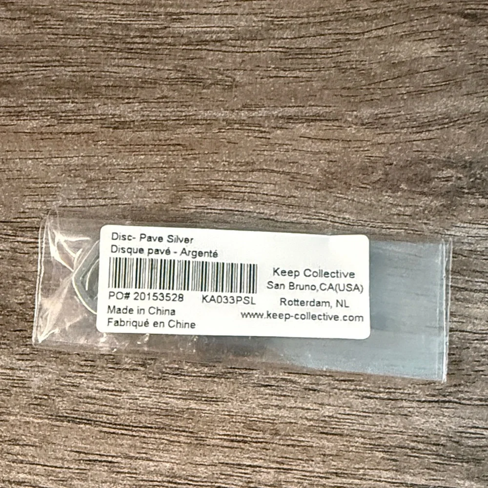 Silver pave disc charm. Keep collective. New in package